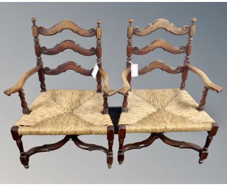 A pair of vintage continental beech rush seated open armchairs.
