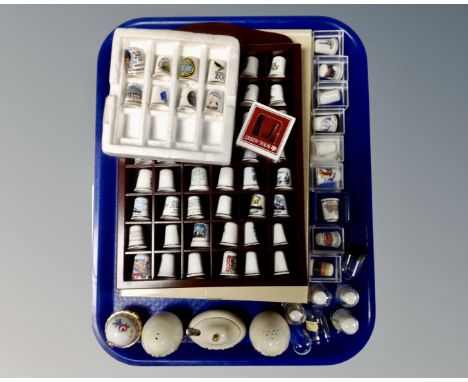 A collection of assorted china thimbles, thimble rack, three piece ceramic cruet set, Leonardo Collection egg containing thim