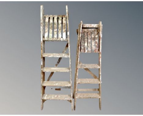 Two sets of vintage folding steps.