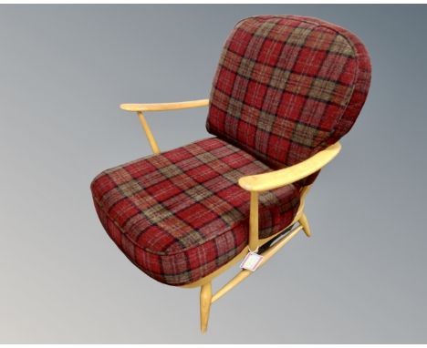 An Ercol elm and beech armchair upholstered in a checked fabric.