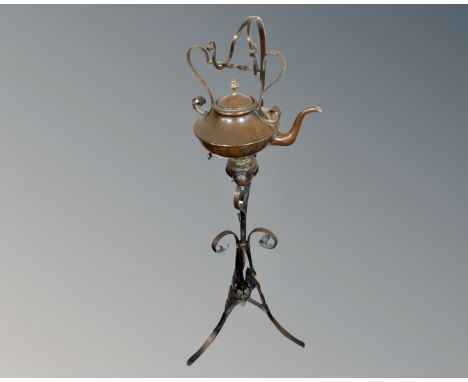 A vintage Arts &amp; Crafts copper kettle with burner on stand 