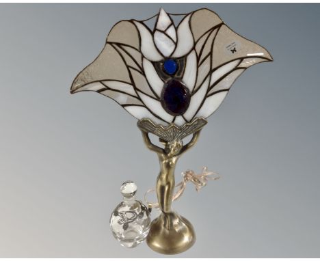 A contemporary Art Deco style figural table lamp together with a flower fairy glass perfume bottle 