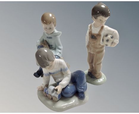Three Nao figures, Boy with Rabbit, Boy with Train and Boy with Football.
