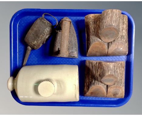 A tray of vintage slip ware hot water bottle, 19th century flat iron, oil can, together with a pair of wooden bookends 
