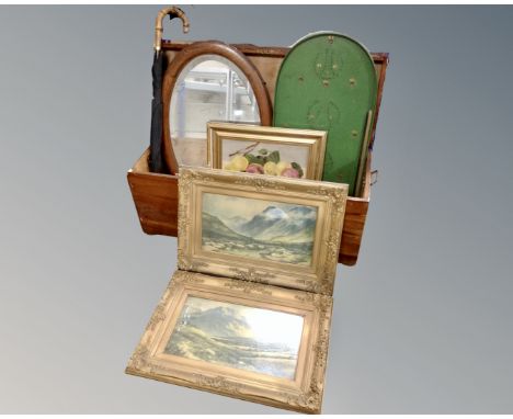 A wooden storage chest containing gilt framed pictures, an Edwardian oak framed mirror, bagatelle board, vintage umbrella.
