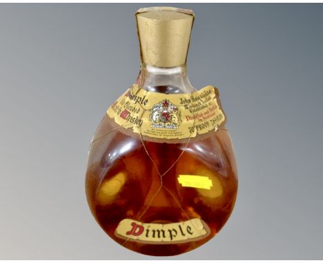 A vintage bottle of Dimple Old Blended Scotch Whisky 70% proof