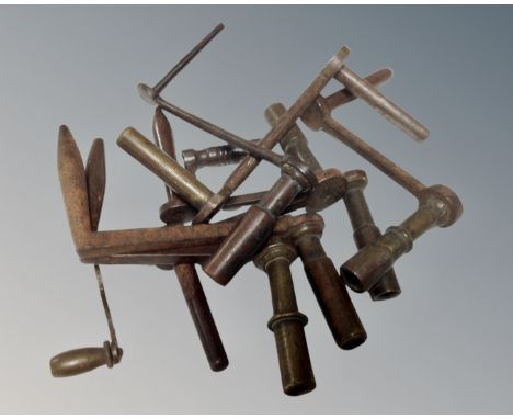A bag containing nine brass and steel longcase clock crank keys.