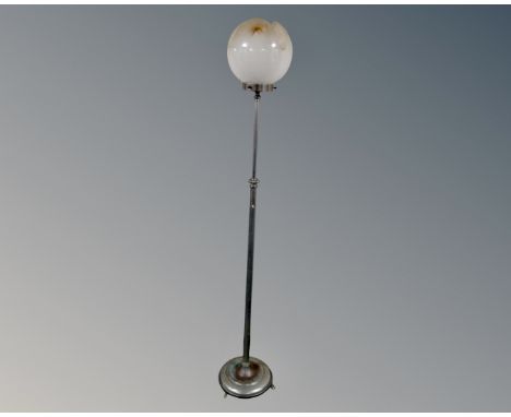 An Art Deco chrome adjustable standard lamp with opaque glass shade.