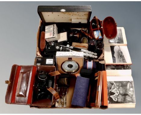 Two boxes containing camera lenses including Canon, Vivitar etc. together with other camera accessories including tripod, cam