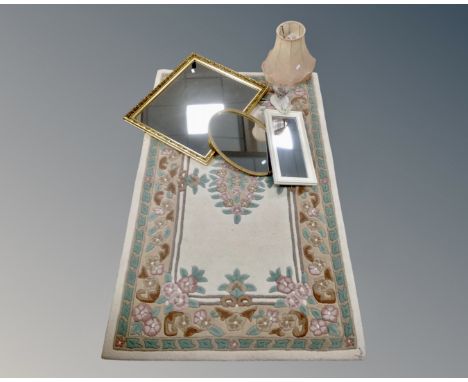 A floral embossed rug on cream ground together with a ceramic table lamp with shade and three mirrors 