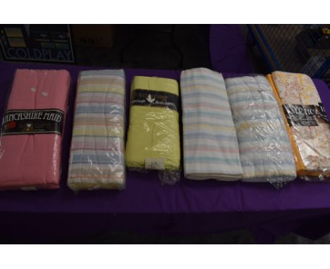 An assortment of vintage and retro bed sheets in original packaging.