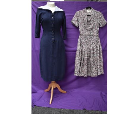 A vintage 1950s St Michaels tea dress with floral pattern and belt and similar navy blue dress with sailor collar and buttons