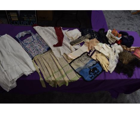 A mixed collection of gloves, aprons, accessories and more including intricately edged antique aprons , handkerchief case and