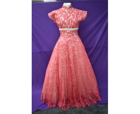 A vintage late 50s/60s pink lace dress having cream velvet band to under bust, tapered bodice into skirt,back metal zipper an