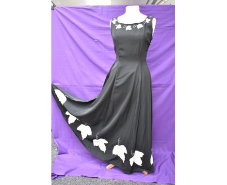 A vintage 1950s evening gown in black having cream ivy appliqué pattern and side metal zipper,small to medium size.