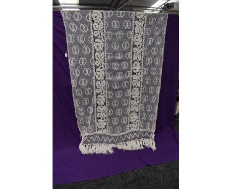 A vintage French tulle curtain with heavy crotched work and fringing.
