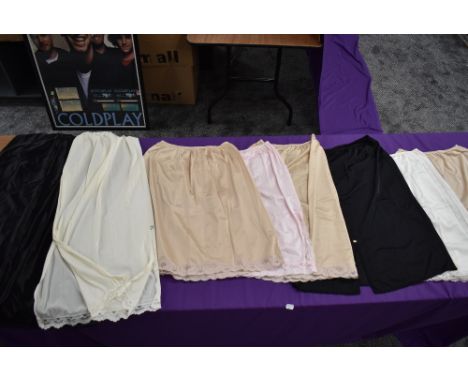 A selection of vintage ladies nylon slips and underskirts.