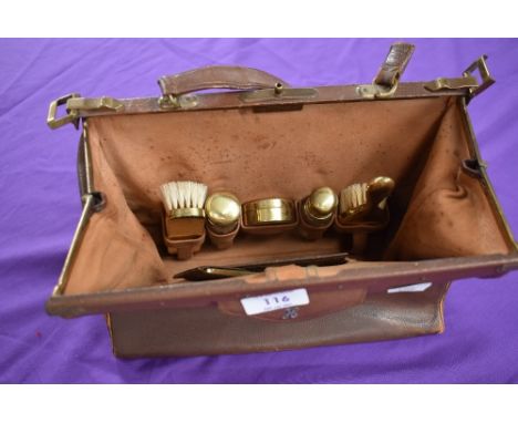 A vintage brown leather clasp top overnight/vanity bag having a set of ladies accessories to internal compartments, monogramm