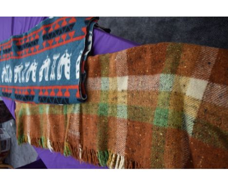 Two vintage rugs,one with pattern to green ground and the other checked in autumnal tones.