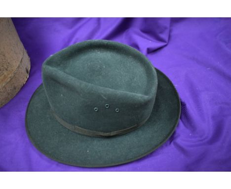 A vintage green felt trilby with hat box.