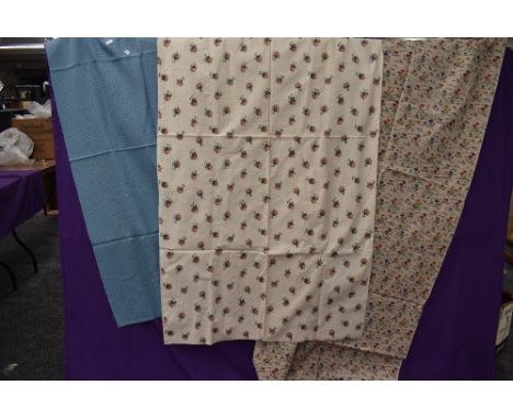 Three lengths of vintage fabrics including bright floral cottons.