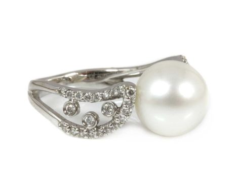 A Continental single stone cultured South Sea pearl ring with diamond set shoulders, with a 9.90mm cultured South Sea pearl, 