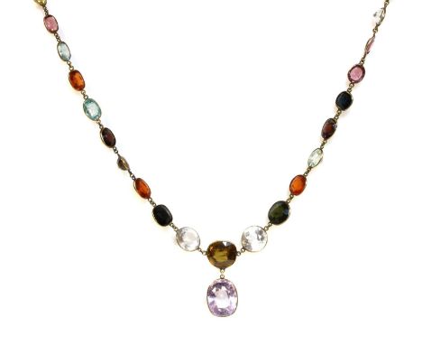 An Edwardian gemstone necklace,with assorted graduated gemstones to include amethyst, zircons, citrines, tourmalines and spin