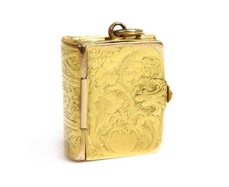 A Victorian rectangular hinged locket of book form,with hand engraved covers and spine. A hinged lock to reveal four locket c