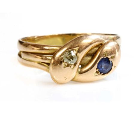 A Victorian 15ct gold sapphire and diamond twin snake ring,with entwined coiled snakes, with crossover heads. Each head grain