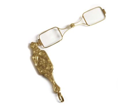 A pair of gold and gilt metal lorgnettes, c.1900, with flat section gold outer covers, decorated with hand engraved floral sp