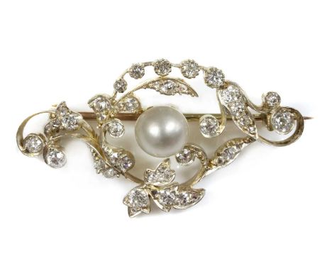 A late Victorian pearl and diamond scrolling brooch,with a slightly bouton-shaped pearl, peg set to the centre. A scrolling f