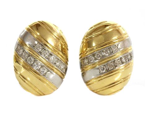 A pair of two colour gold diamond set oval domed earrings,with two diagonal white bands to the centre, grain set with brillia