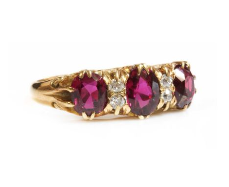 A seven stone ruby and diamond carved head ring,with three graduated oval mixed cut rubies, all double claw set. Pairs of old