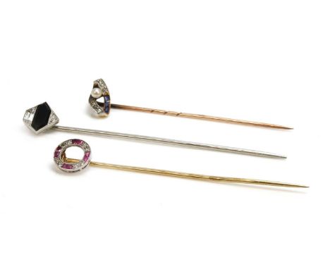 Three Art Deco diamond set stick pins, to include a French platinum pentagonal example, with a tapered hexagonal black glass 