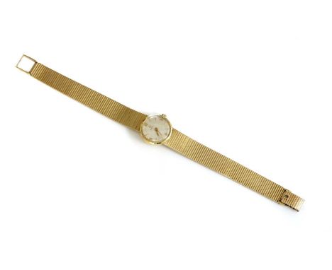 A ladies' 9ct gold Omega mechanical bracelet watch, c.1960,with a circular 19.50mm case. A silvered dial, raised gilt batons 