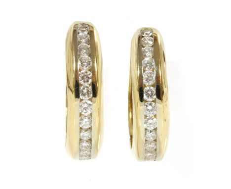 A pair of Continental gold diamond set hoop earrings,with a row of brilliant cut diamonds, channel set to the front. A 'D' se