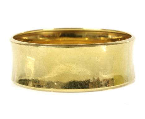 A Continental gold convex bangle,marked 18K 750. 24mm wide, 65mm interior diameter, 68.56gCondition report: Surface scuffs an
