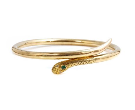 An early 20th century gold emerald and diamond set serpent or snake bangle,for the upper arm, by Cornelius Desormeaux Saunder