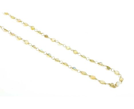 An opal necklace,with a series of circular cabochon opals, each one spectacle set in a plain collet, all joined by jump rings