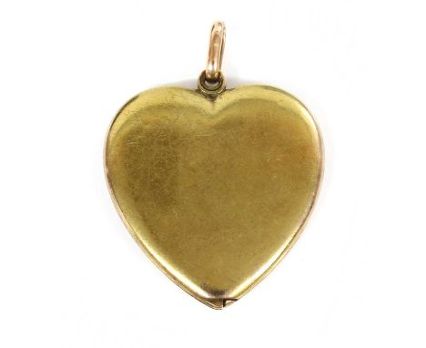 A gold heart-shaped swivel locket, c.1910,with plain covers and large oval bale. Tested as approximately 15ct gold. 55 x 40mm