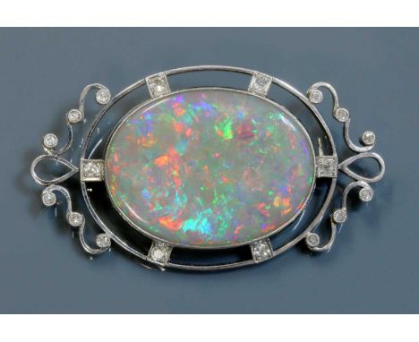 An Edwardian white gold opal and diamond brooch,with an oval cabochon opal, milligrain set in a plain shallow collet. An open