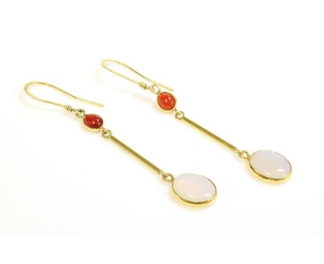 A pair of gold fire opal and opal drop earrings,with an oval cabochon fire opal, spectacle set to the top. A flat section bar