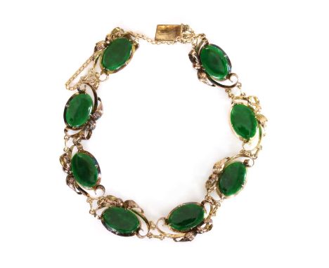 A jade bracelet, c.1950,with a series of jade oval cabochons, probably nephrite, each one four claw set to a flared collet, w