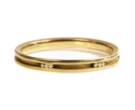 A gold band ring by Georg Jensen,no. 1060B, 2.4mm wide, with raised dots and guards, marked 18k 750. Georg Jensen mark, 1945 