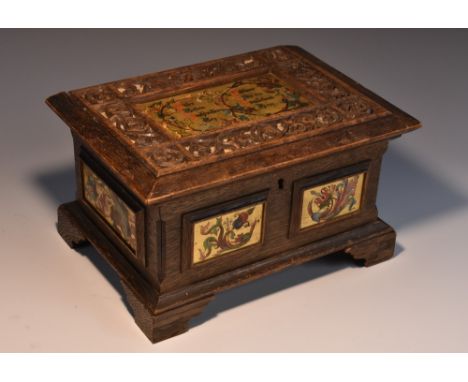 A Gothic Revival gilt and polychrome decorated oak work box, hinged cover with blind tracery border, applied with panels of v