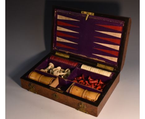 A Victorian burr walnut rectangular games compendium, hinged cover applied with Gothic cut-card work, enclosing a pair of box