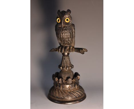 A 19th century Irish bog oak model, carved as an owl on a perch, engine turned base with shamrock border, 21cm high, c.1880