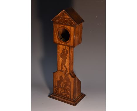 An early 20th century oak and marquetry novelty pocket watch stand, as a longcase clock, inlaid with figures from folklore, p