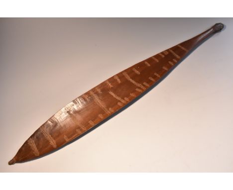 Tribal Art - an Australian Aboriginal hardwood woomera spear thrower, of typical broad leaf shape and incise carved with band