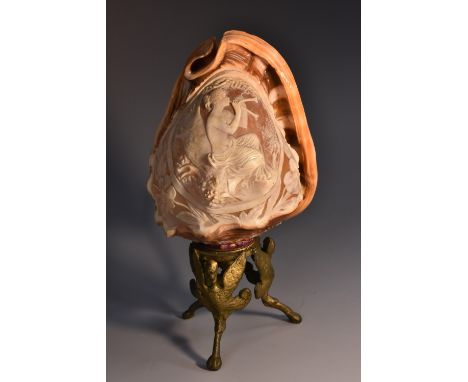 An early 20th century conch shell cameo lamp, carved with Euterpe, Muse of Music and Song, gilt-metal base cast with winged m